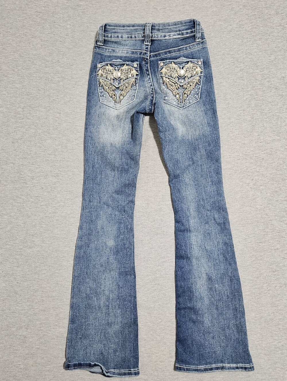 Telepatia blue bootcut low rise jeans with heart and wing design on back pockets
